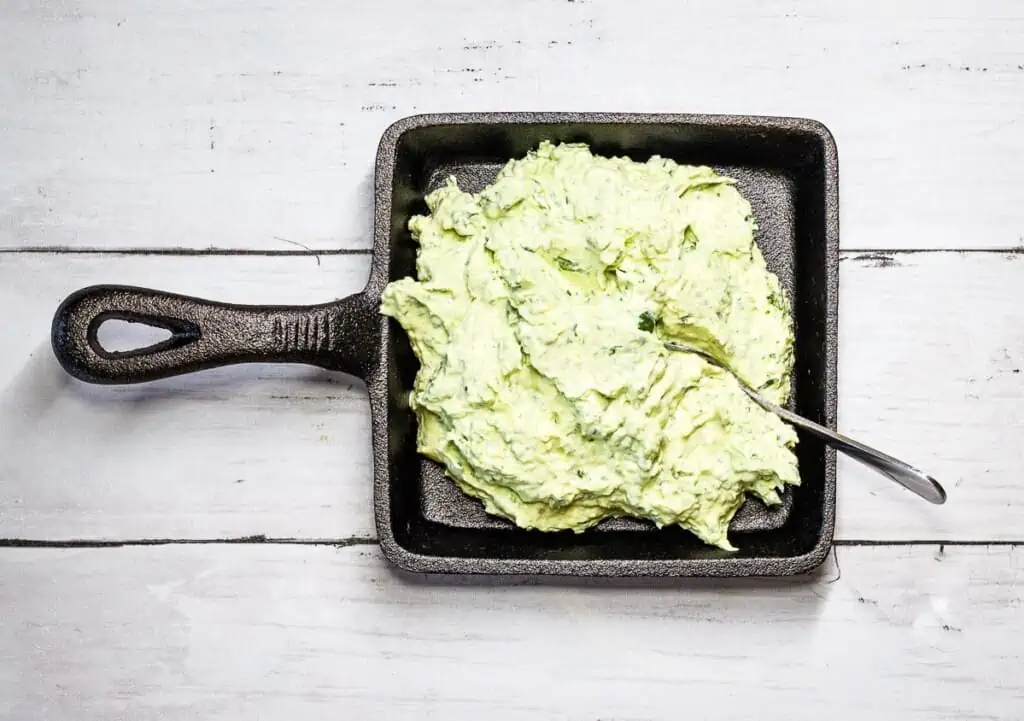 Creamy green goddess dip in a black dish.