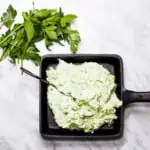 Keto Green Goddess Dip in a black cast iron dish.