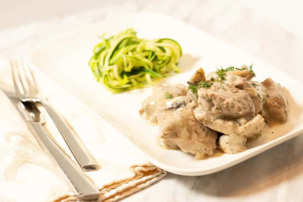 Keto-friendly Pork Stroganoff with Dill served with zucchini spaghetti.