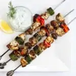 three keto and low carb lemon-oregano chicken kabobs with tzatziki on the side