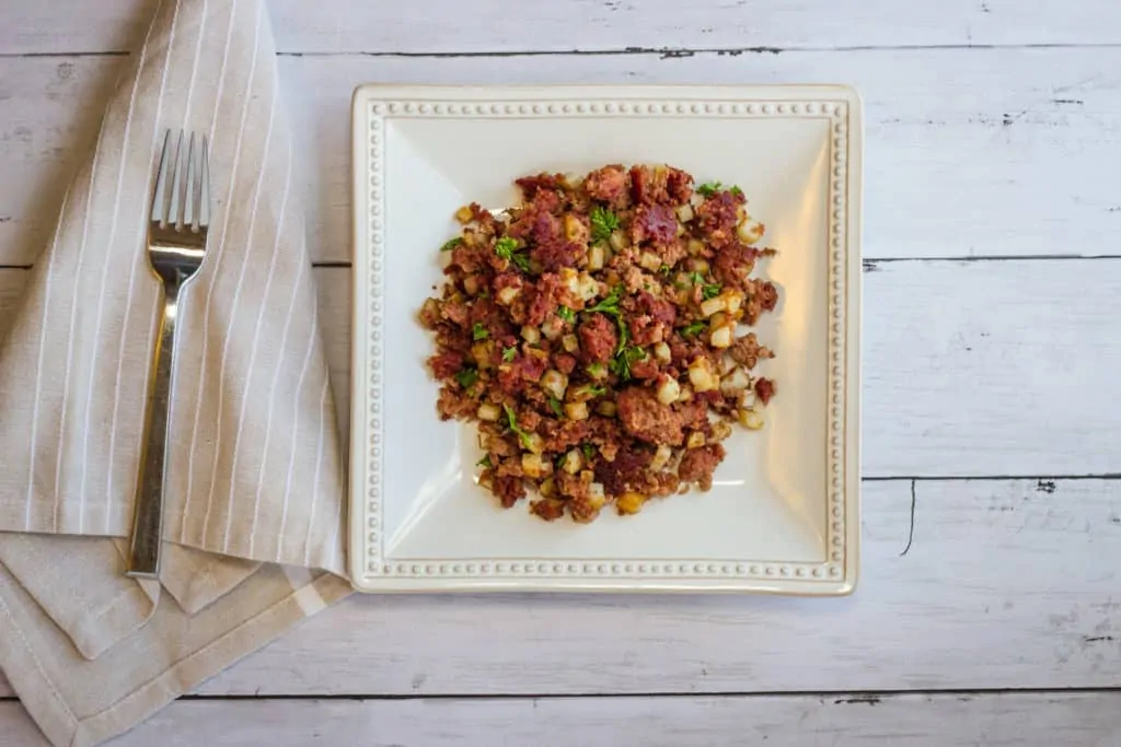 Keto-friendly corned beef hash on a square plate.