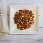 Keto-friendly corned beef hash on a square plate.