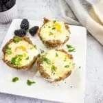 keto sausage egg cups on a white plate with blackberries
