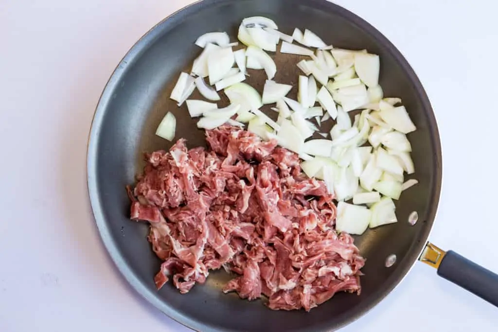 philly beef and onions in a skillet