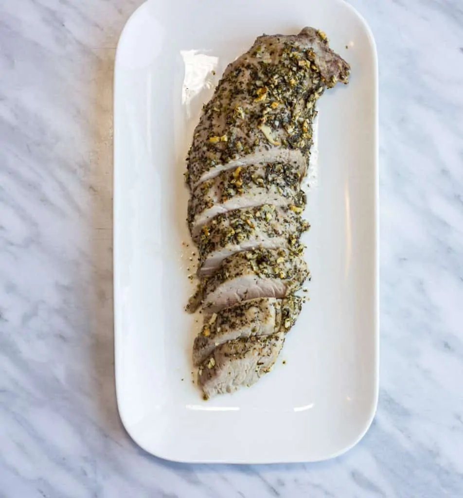 Sliced Garlic & Herb Roasted Pork Tenderloin on a platter.