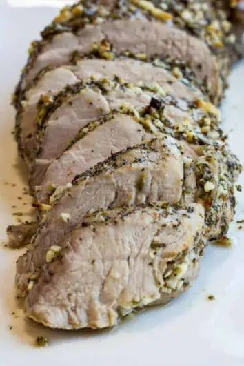 Garlic & Herb Roasted Pork Tenderloin slice on a platter.