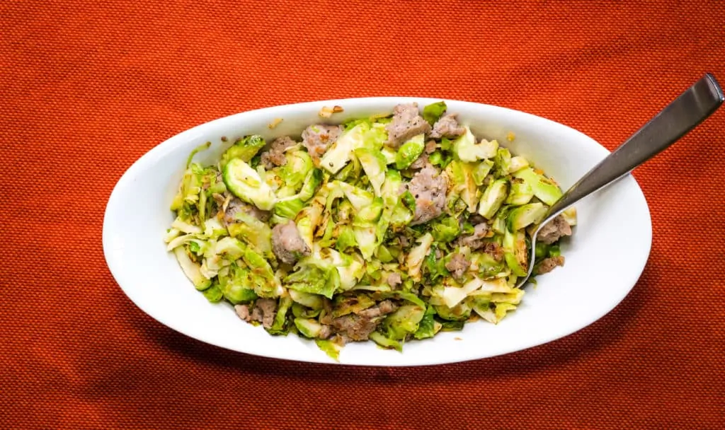Keto and low-carb Italian Brussels Sprouts with Sausage in a serving bowl