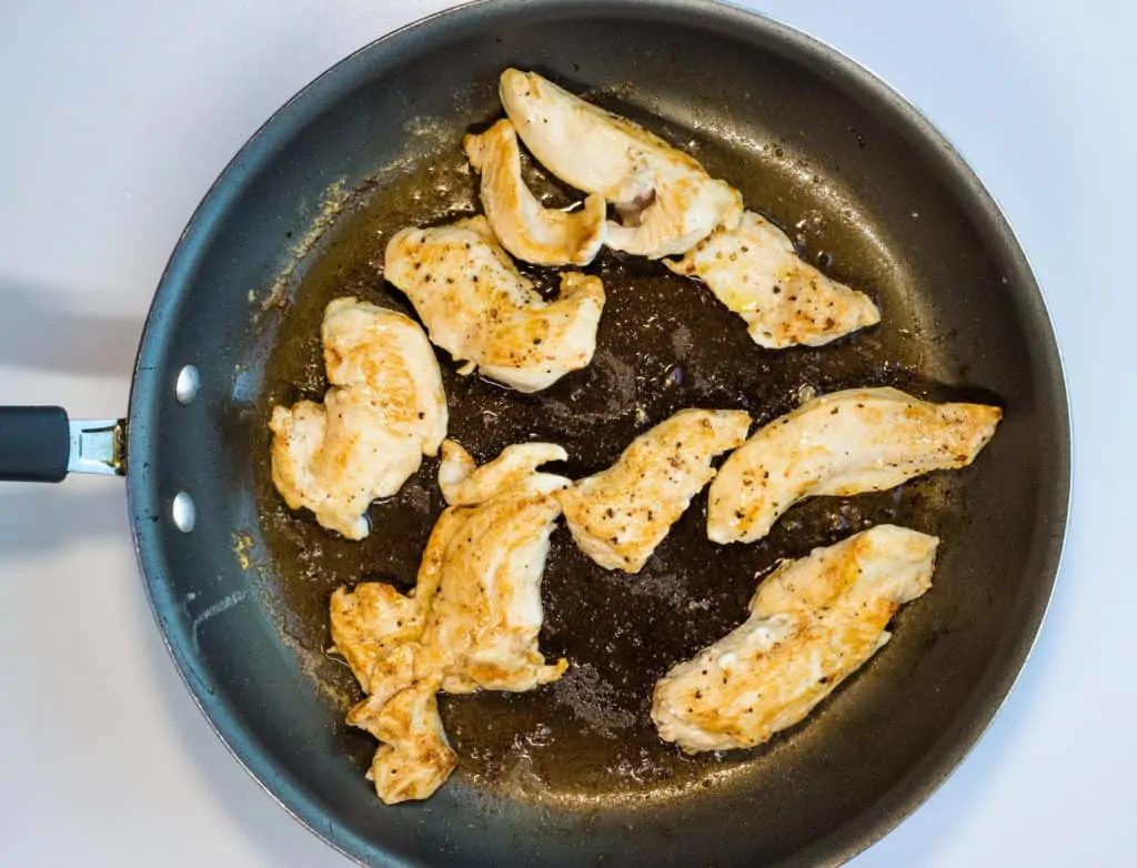 browning the chicken tenders in a skillet.