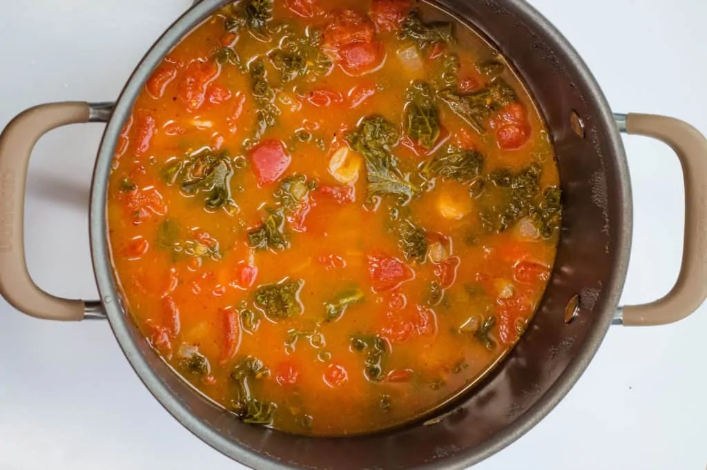 beef, tomatoes and juice, and veggies in a pot after simmering