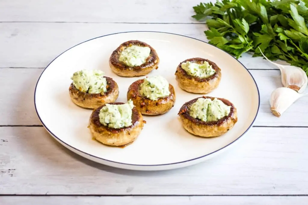 green goddess stuffed mushroom caps on a plate