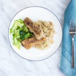 meaty ribs and sauerkraut on a plate with zucchini noodles