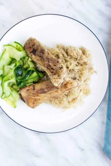 meaty ribs and sauerkraut on a plate with zucchini noodles