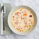 a bowl and spoon of keto shrimp and chipotle chowder