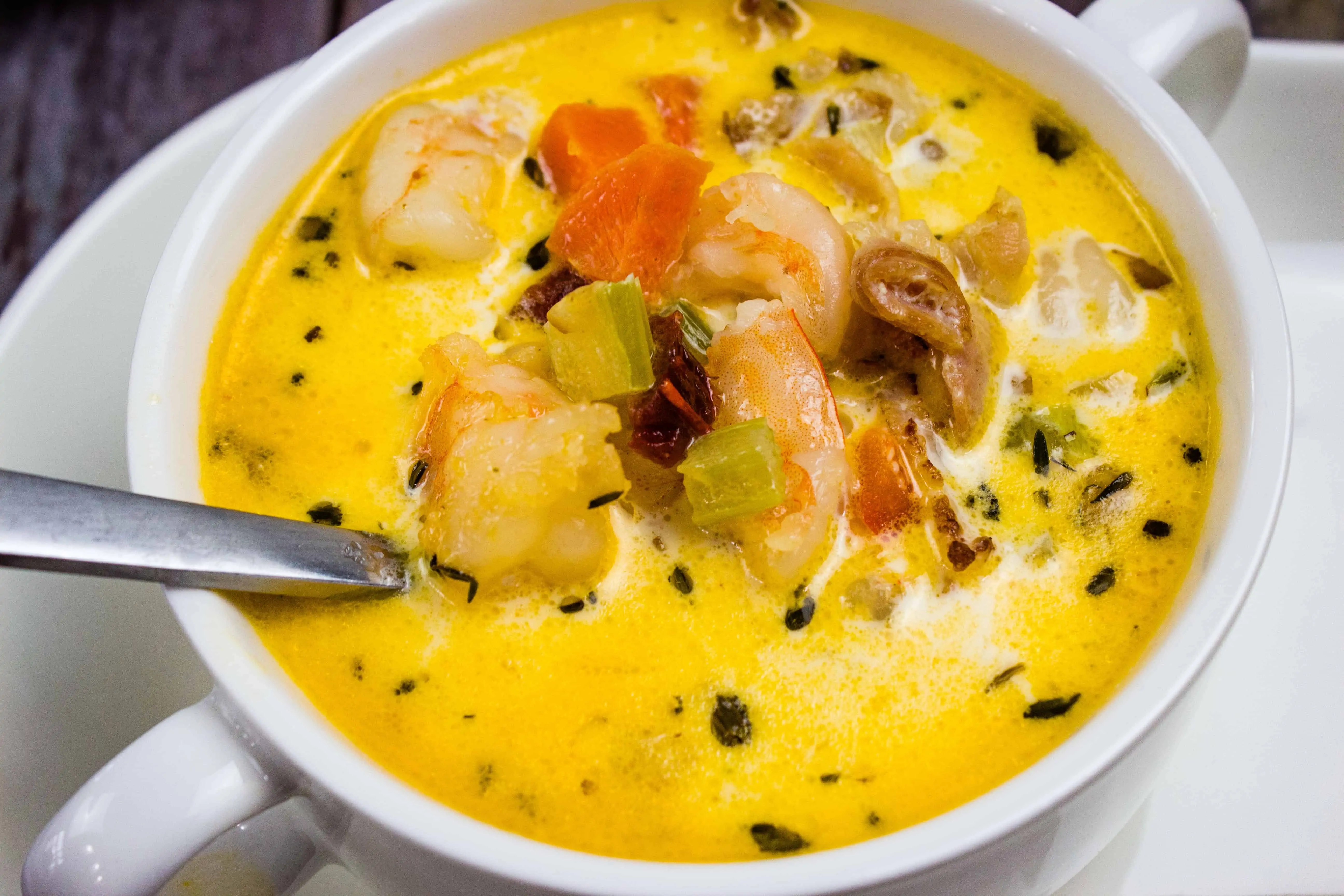 a bowl of shrimp and chipotle chowder with a spoon in it