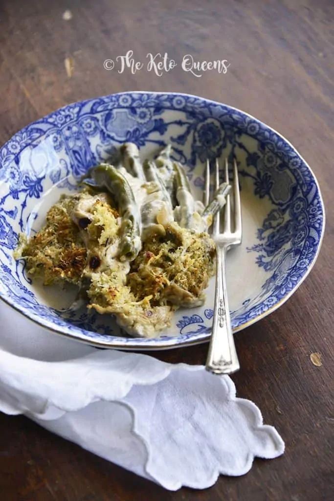Keto Instant Pot Green Bean Casserole in a porcelain bowl with a silver fork.