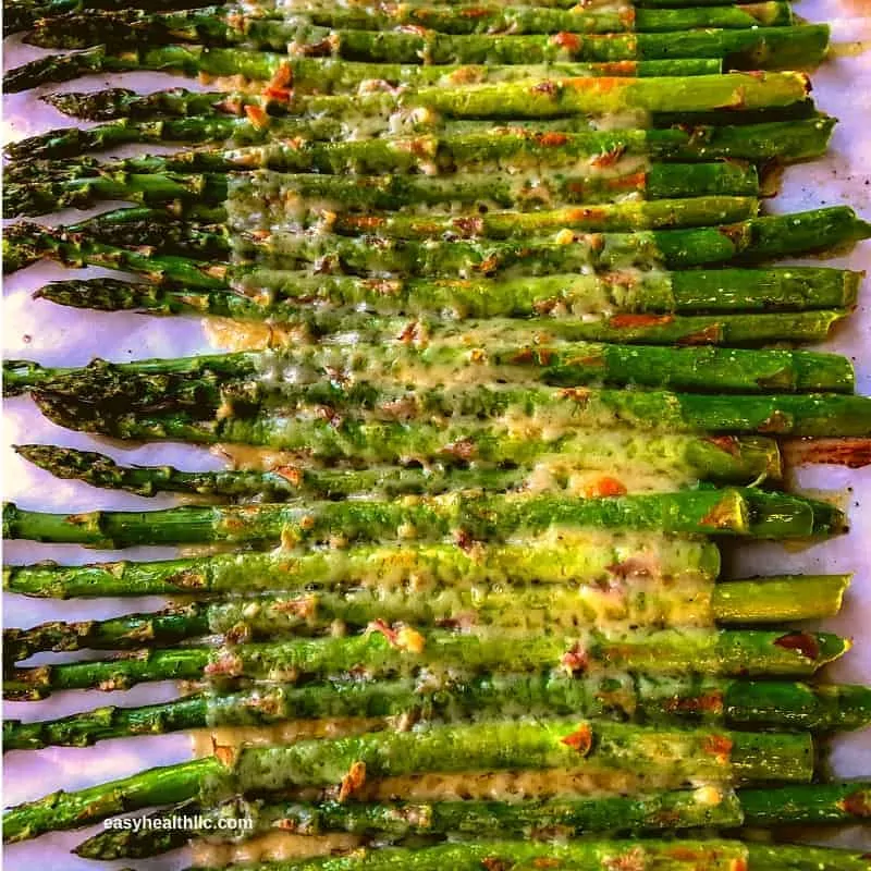 keto side dish recipe of cheesy roasted asparagus on a pan