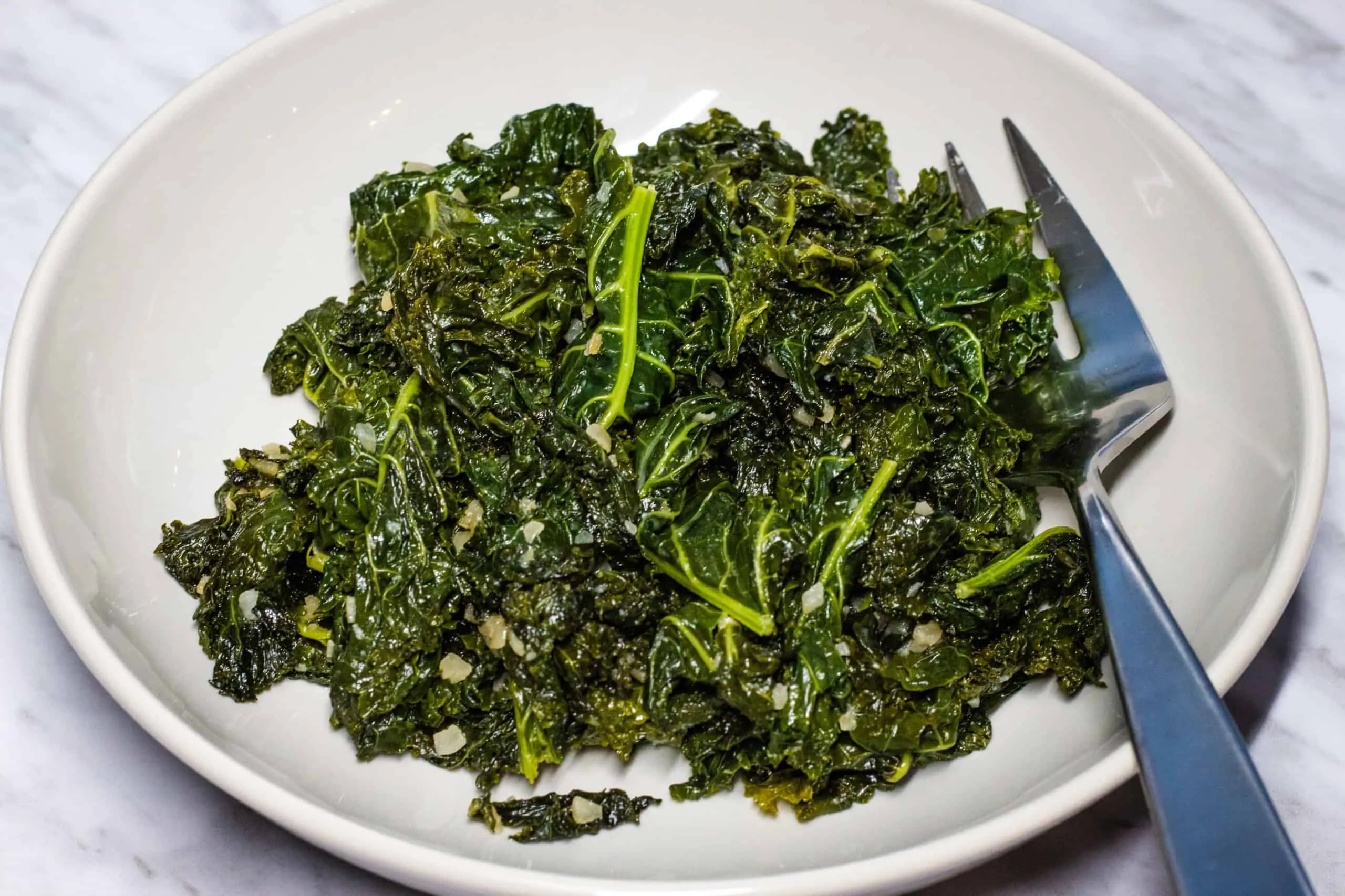 Skillet Braised Kale with Garlic in a serving dish.