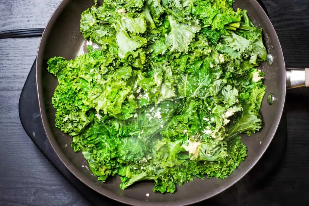 braised kale cooking in a skillet