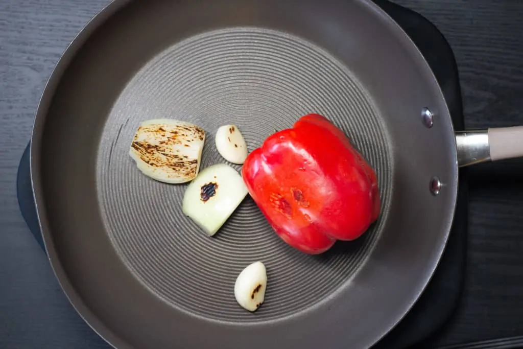 Red pepper, onion and garlic after roasting in a skillet