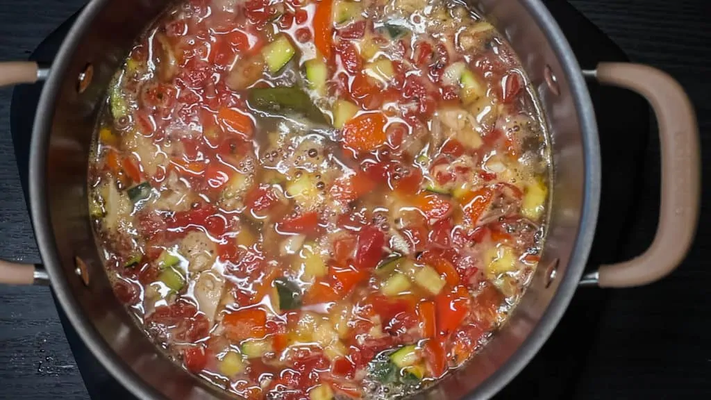 All recipe ingredients simmering in a pan.