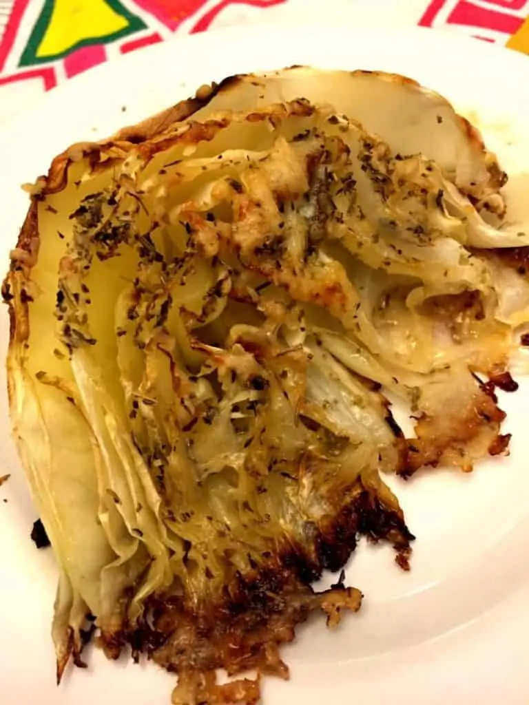 Parmesan Roasted Cabbage Wedge on a round white plate.