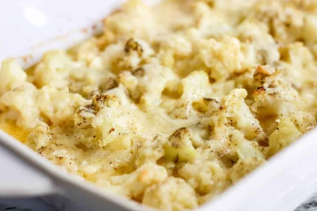 Closeup of Cheesy Cauliflower Bake in a rectangular white serving dish.