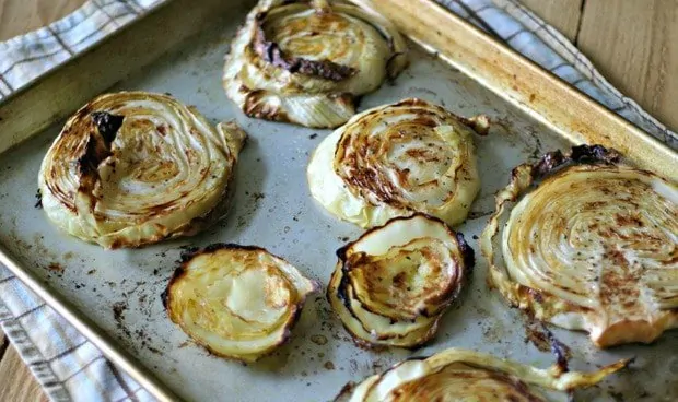 Seven Garlic Rubbed Cabbage Steaks on a sheet pan, browned from the oven.