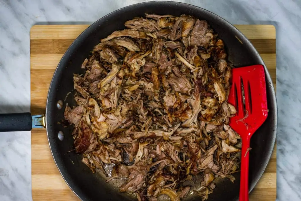 browned and crisped pork in a skillet