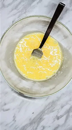 mixing the eggs and cream