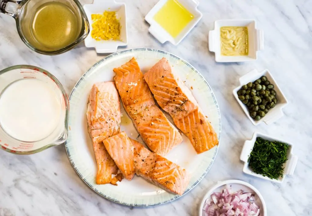 cooked salmon and prepped ingredients to make keto salmon with lemon dill cream sauce