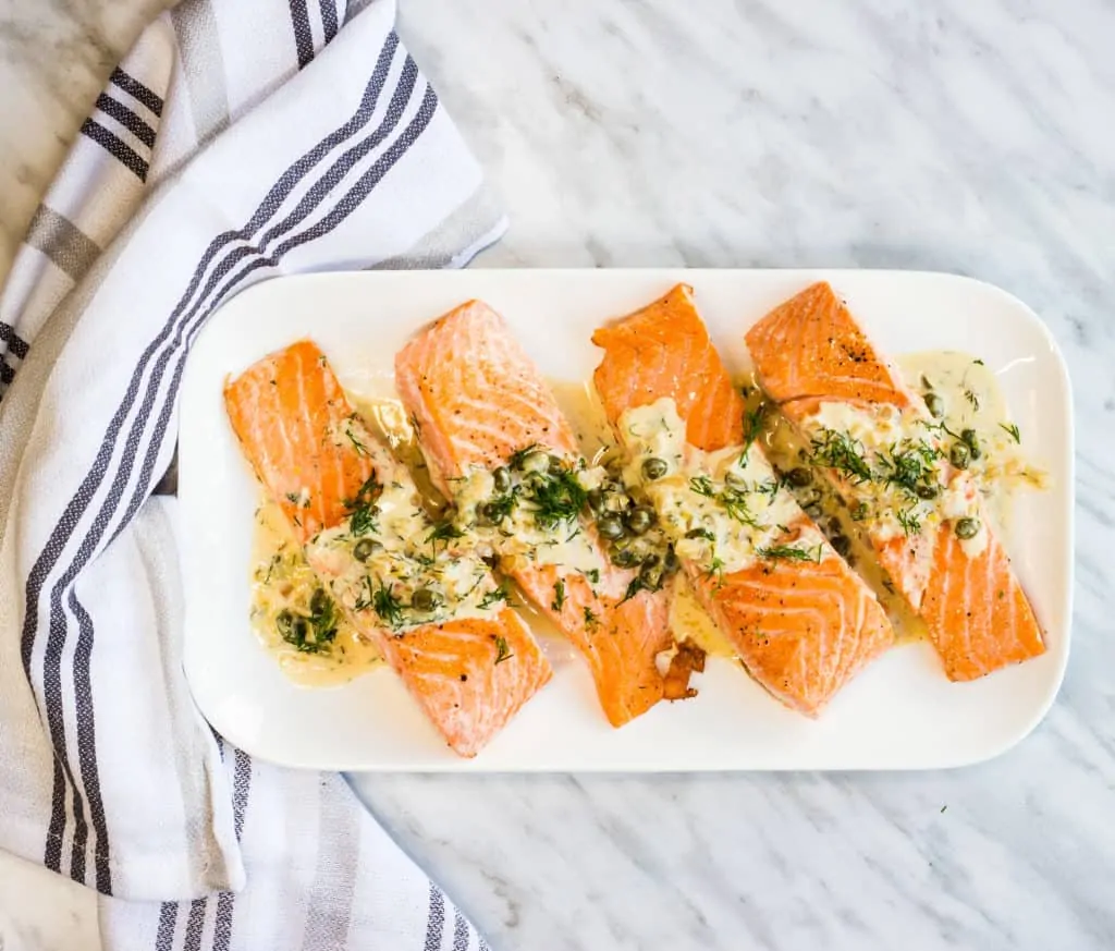 keto salmon with lemon dill cream sauce on a serving plate