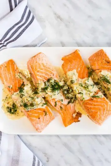 keto salmon with lemon dill cream sauce on a serving plate