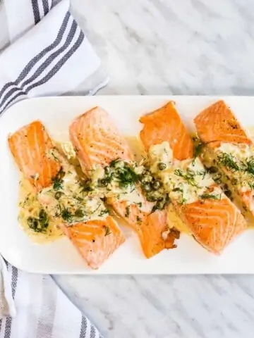 keto salmon with lemon dill cream sauce on a serving plate