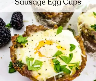Sausage Egg Cups on a white plate with berries on the side.