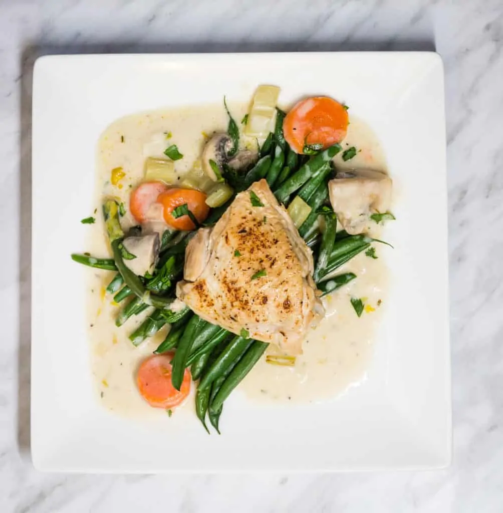 creamy country chicken on a plate with green beans