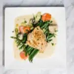 creamy country chicken on a plate with green beans
