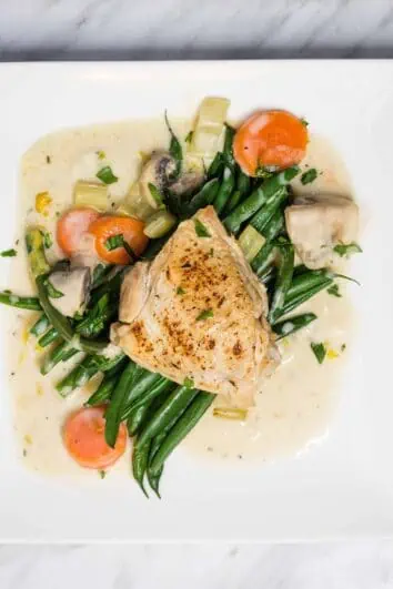 creamy country chicken on a plate with green beans