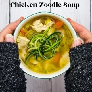keto chicken zoodle soup in a bowl held between two hands