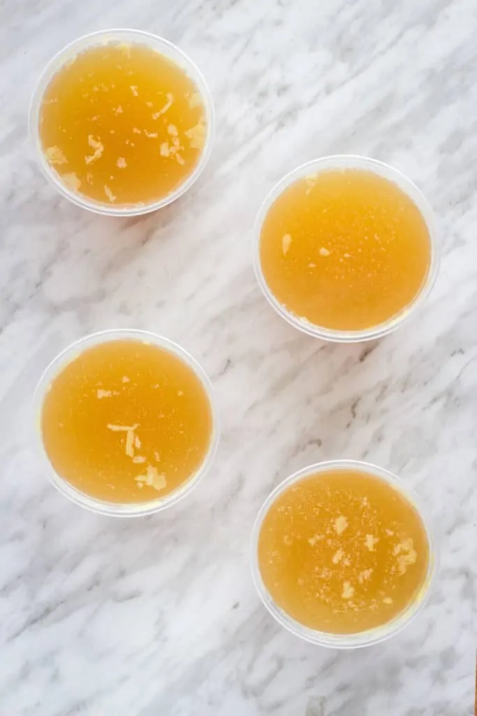 homemade turkey stock in containers for freezing