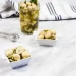 marinated mushrooms in a jar and in square serving dishes