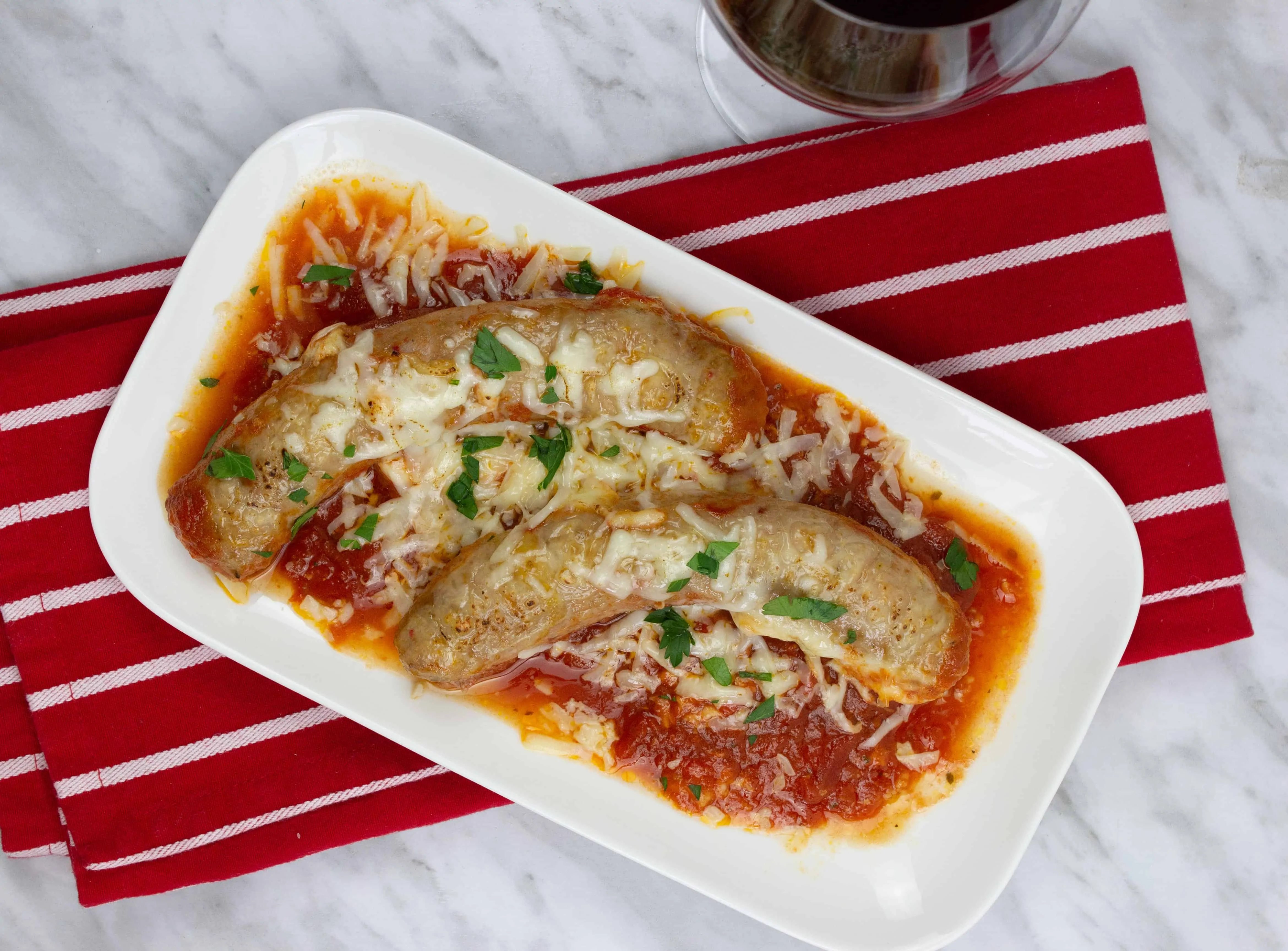 Sausage Parmigiana on a white plate