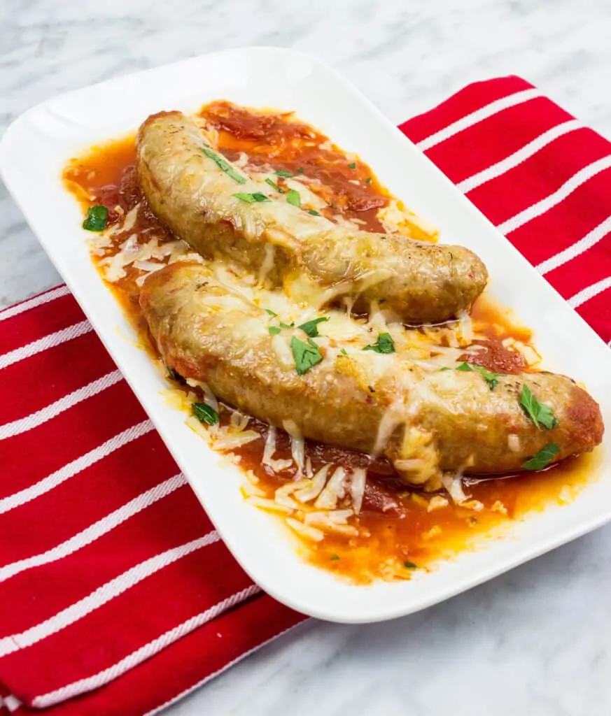 sausage parmigiana on a white serving dish