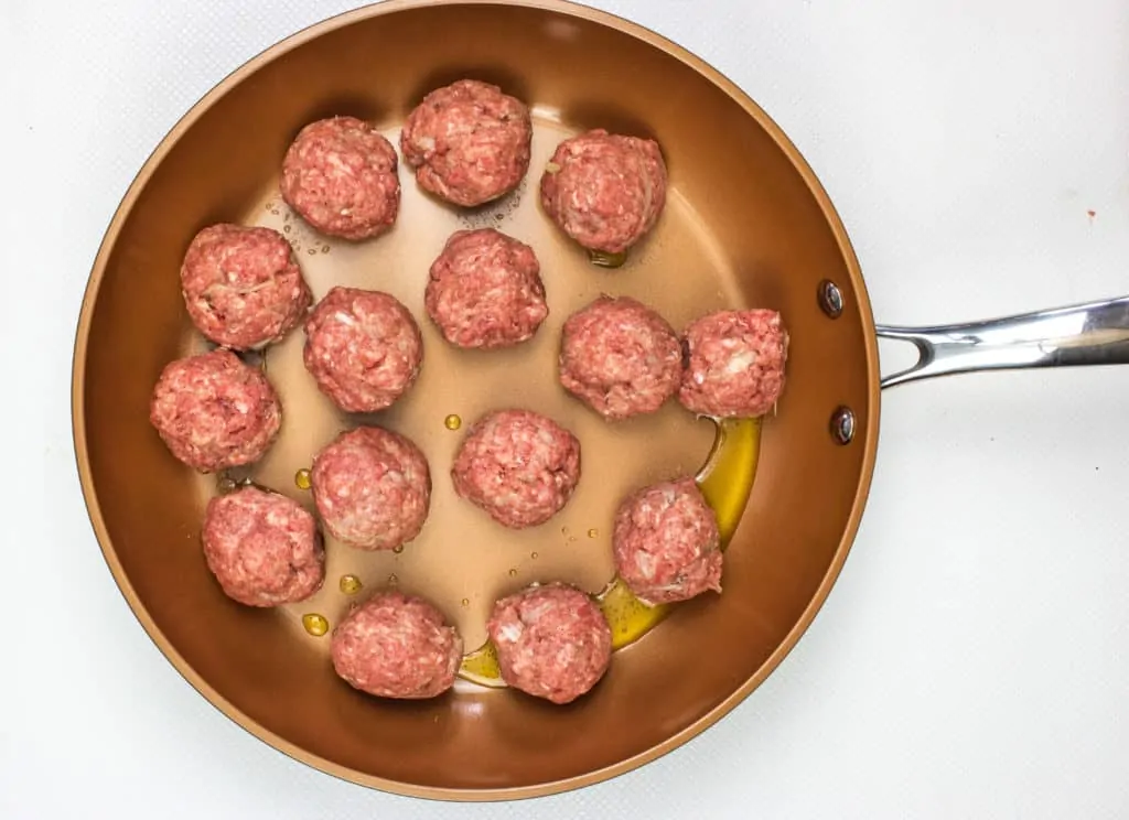 cooking the meatballs in a skillet
