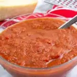 keto tomato sauce in a bowl with parmesan in the background