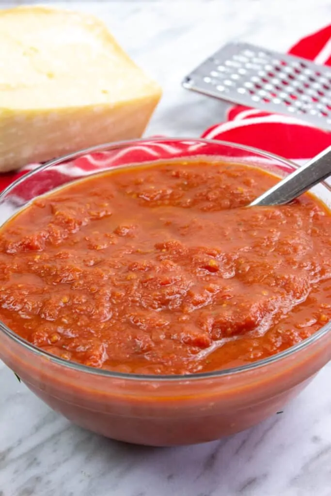 keto tomato sauce in a bowl with parmesan in the background