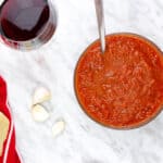 oven roasted tomato sauce with a glass of wine nearby