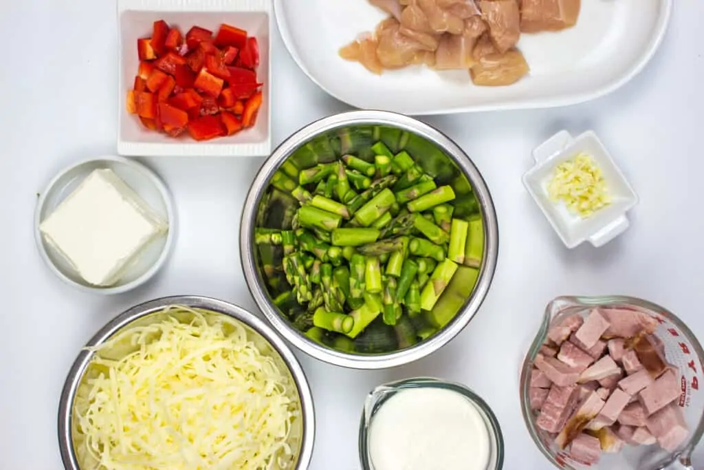 prepped ingredients - diced chicken, ham, asparagus, bell peppers and more
