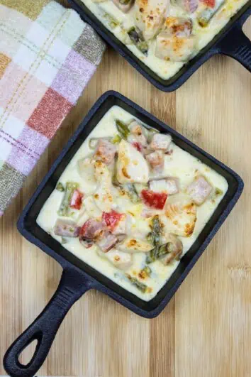 chicken, ham, and asparagus casserole in two square serving dishes