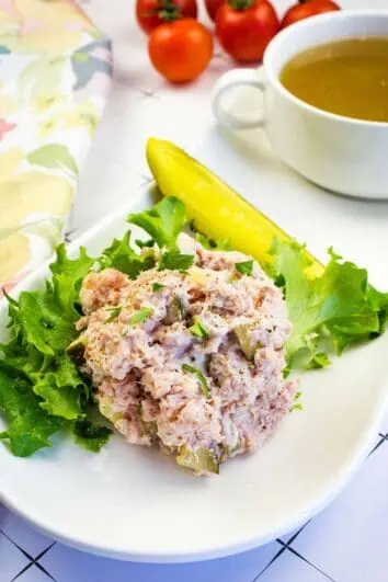 keto ham salad on a plate with a bowl of broth in the background