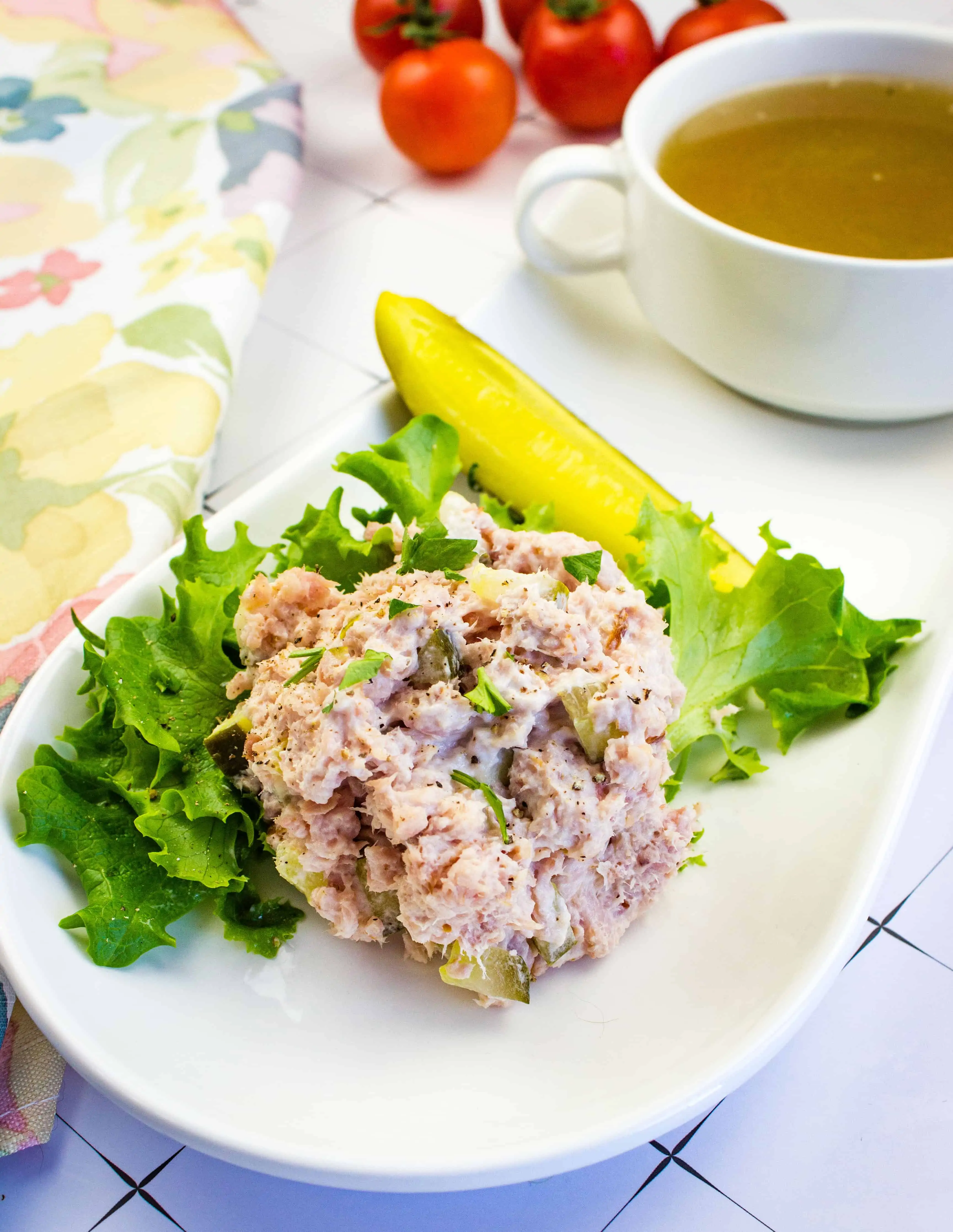 keto ham salad on a plate with a bowl of broth in the background